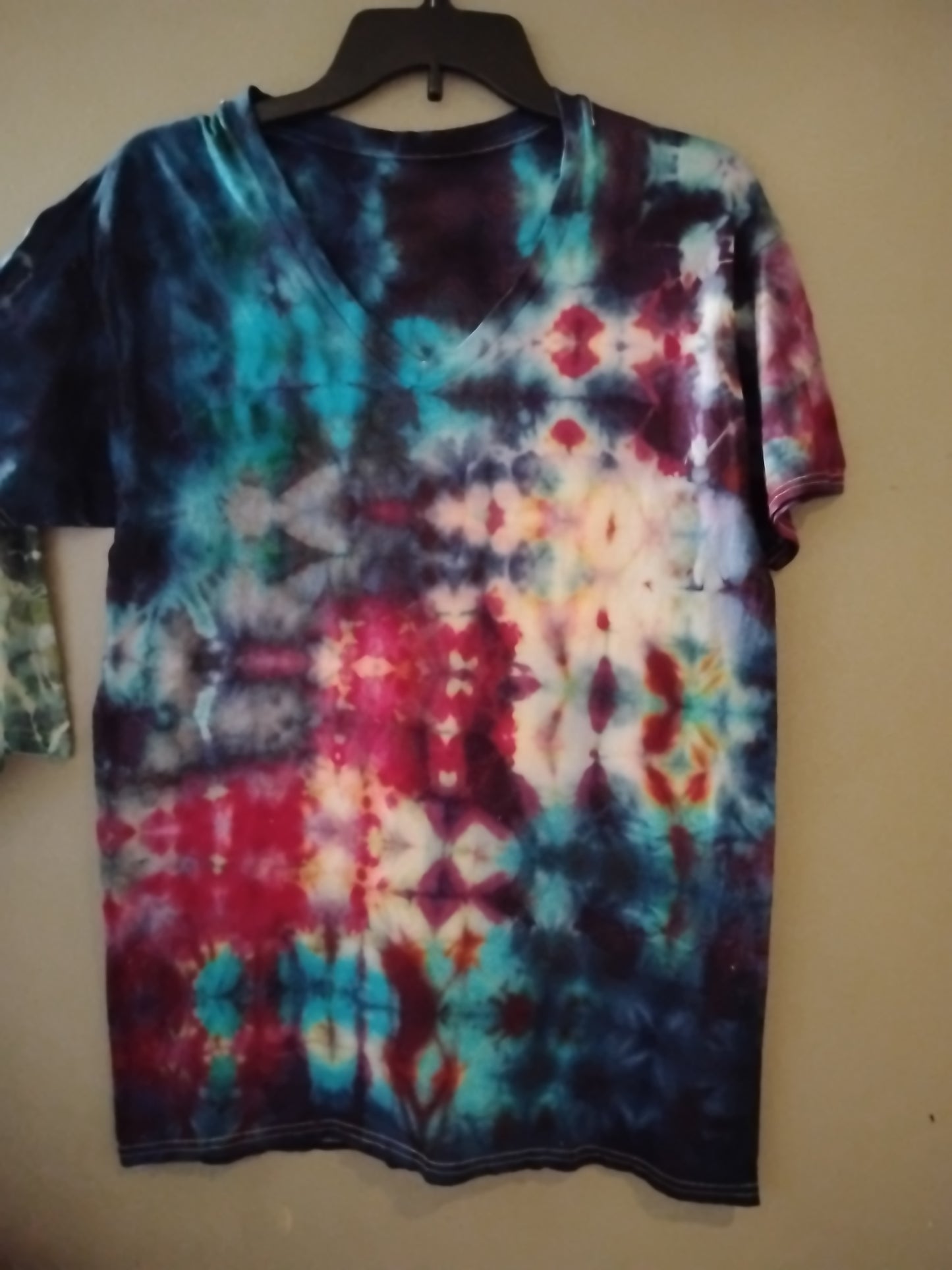 Handcrafted and tie-dyed glitch technique over a size medium v-neck short sleeve t-shirt