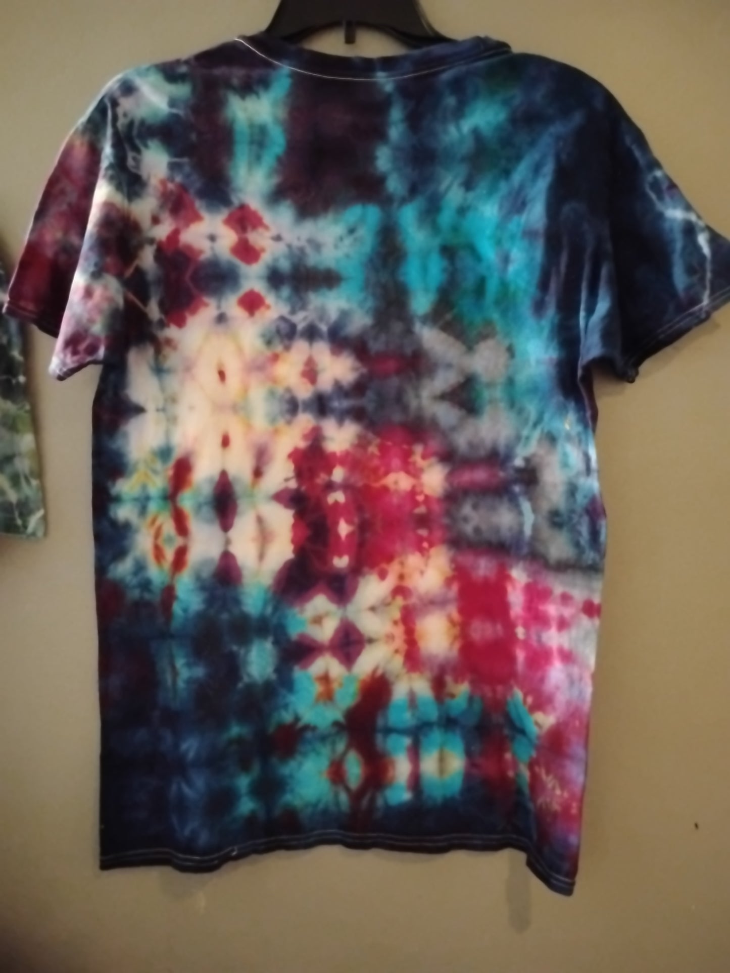 Handcrafted and tie-dyed glitch technique over a size medium v-neck short sleeve t-shirt